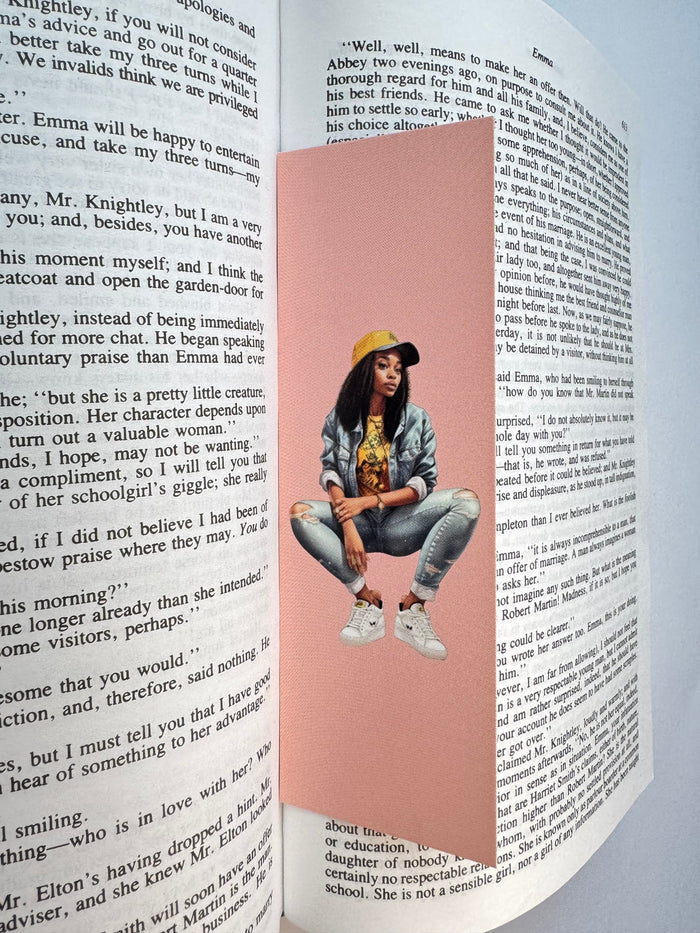 A handmade illustrated bookmark resting in an open book
