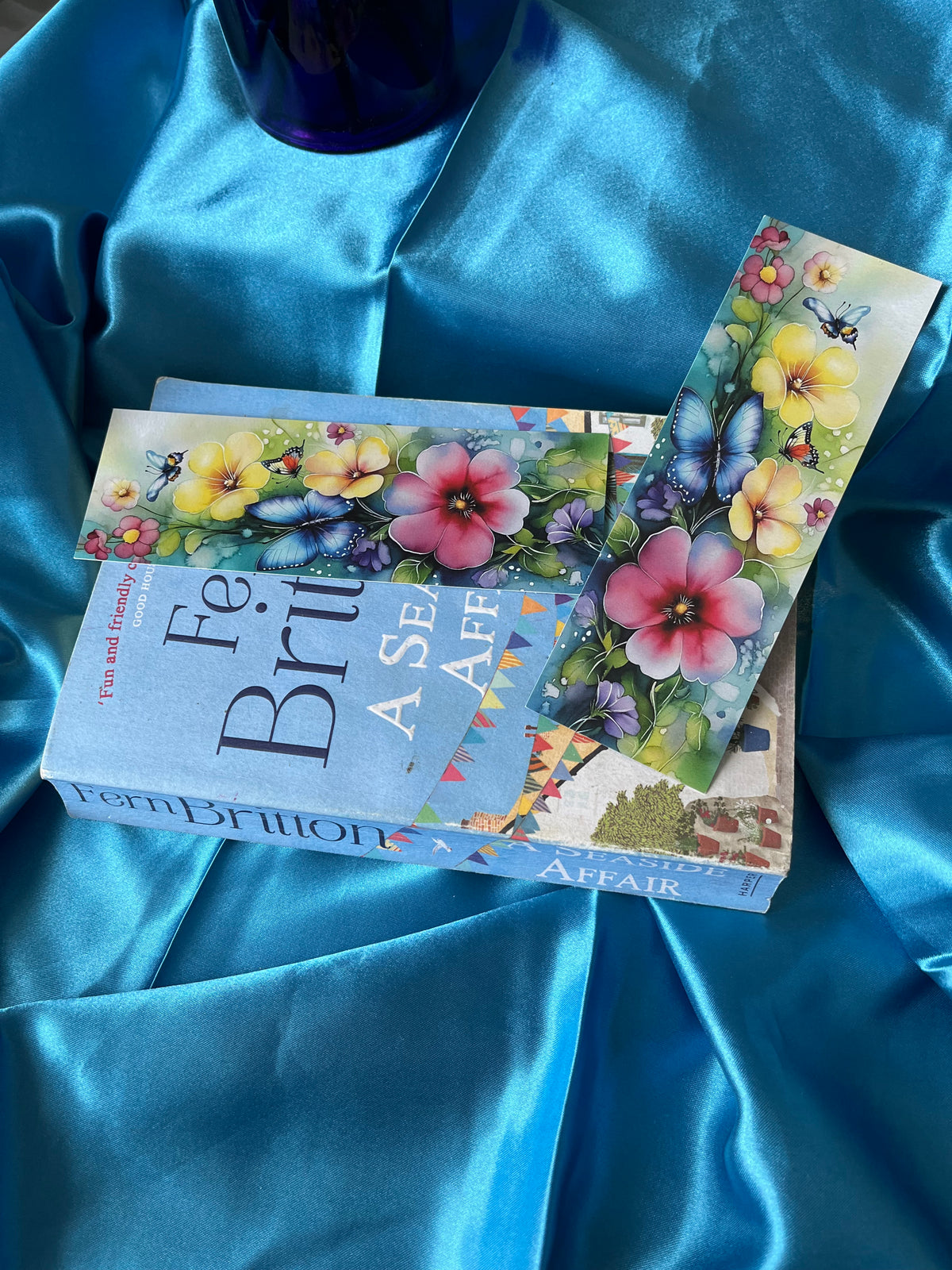A handmade bookmark decorated with flowers and butterflies