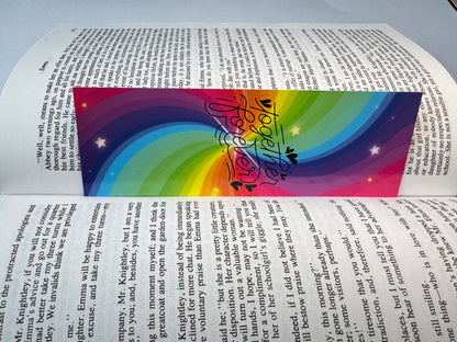 A handmade rainbow pride bookmark in bright stripes