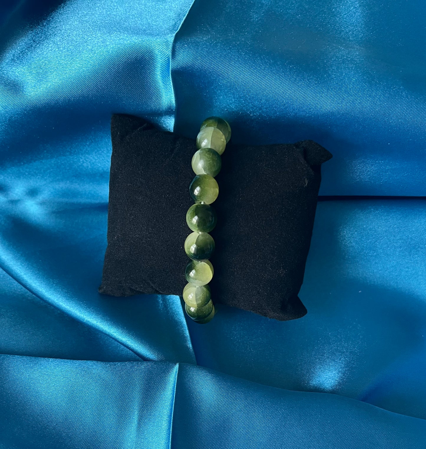 A handmade yellow and green glass bead stretch bracelet
