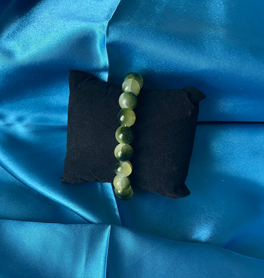 A handmade yellow and green glass bead stretch bracelet
