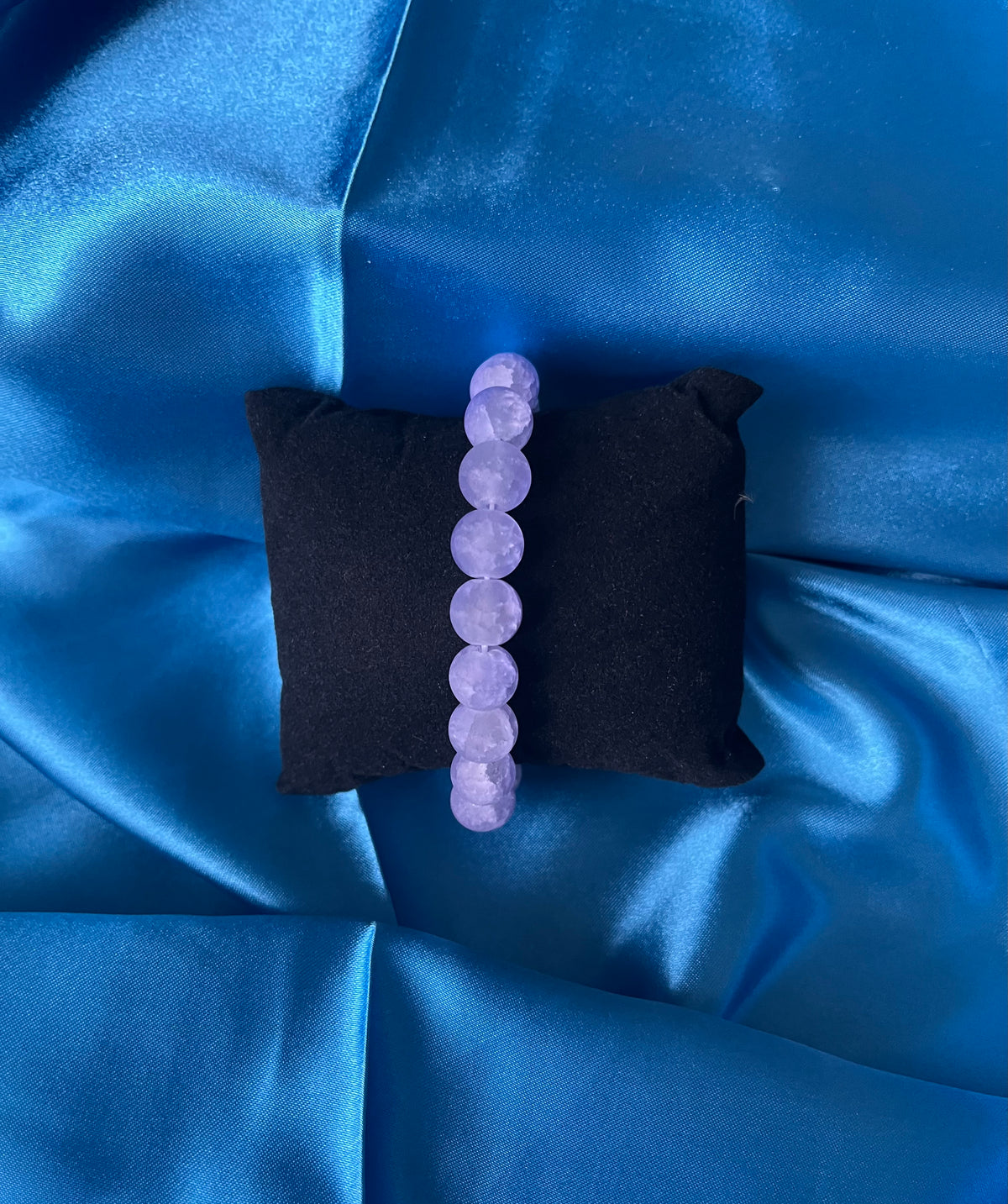 A handmade purple glass bead stretch bracelet