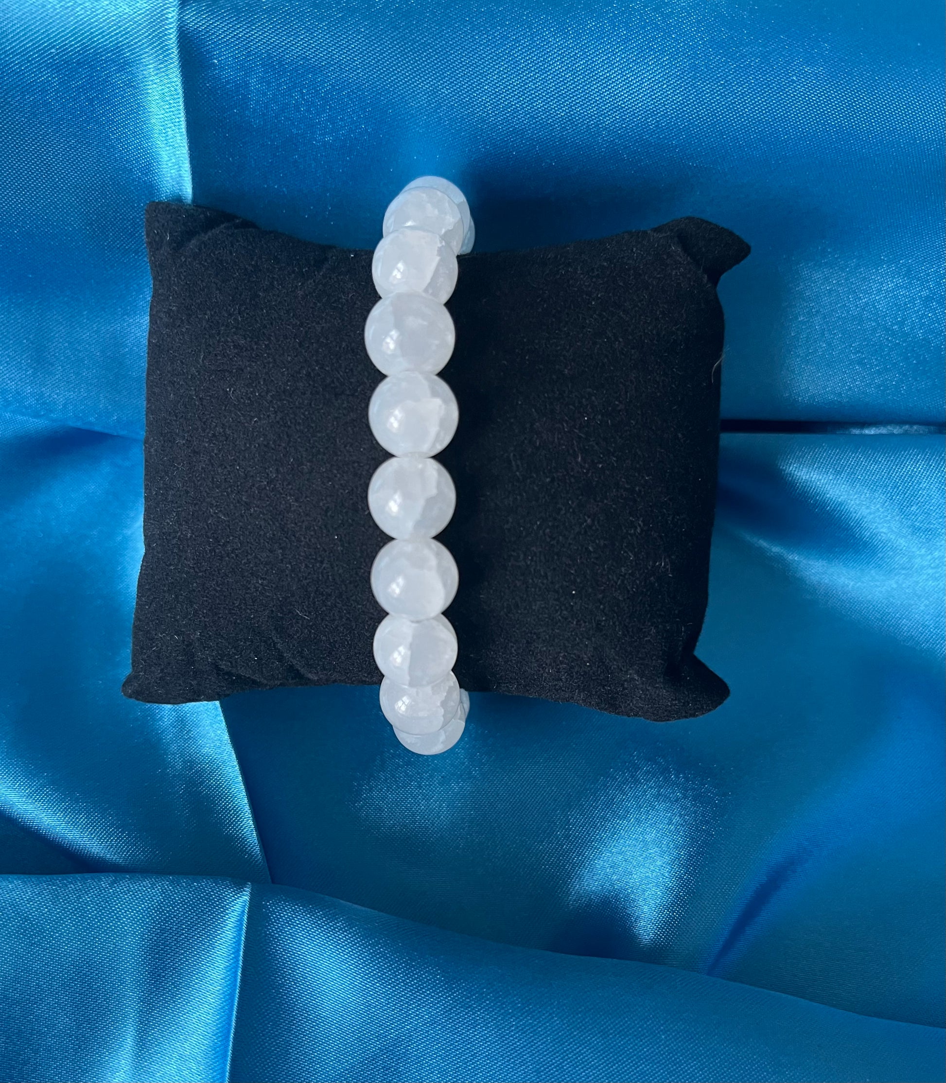 A handmade white glass bead stretch bracelet