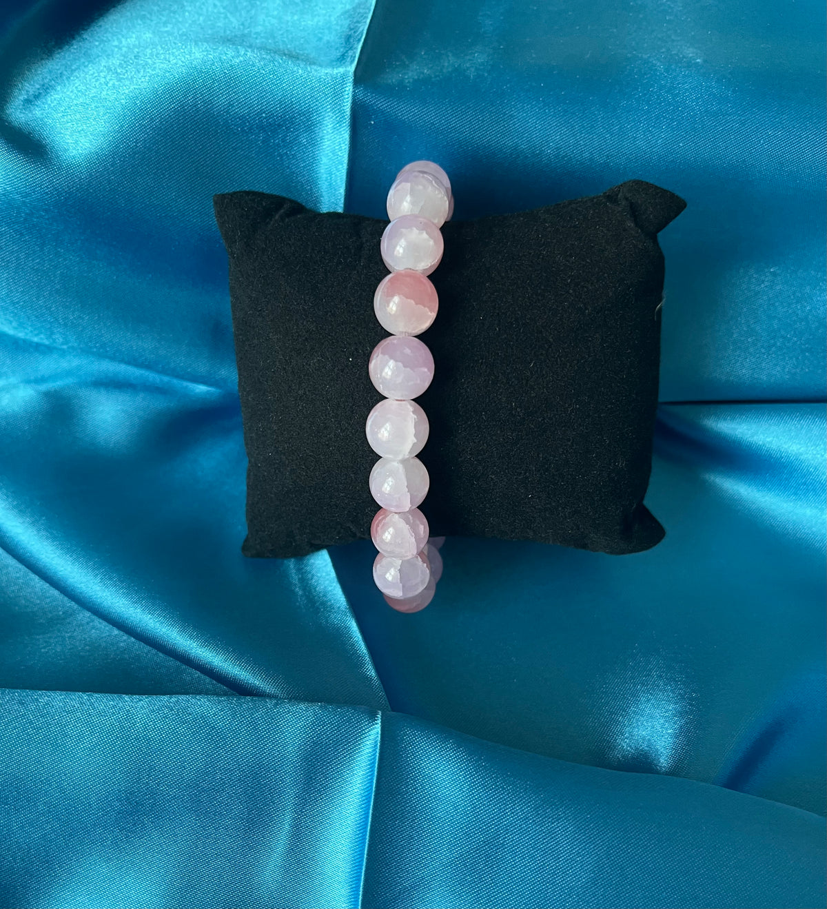 A second photograph of the handmade pink glass bead stretch bracelet