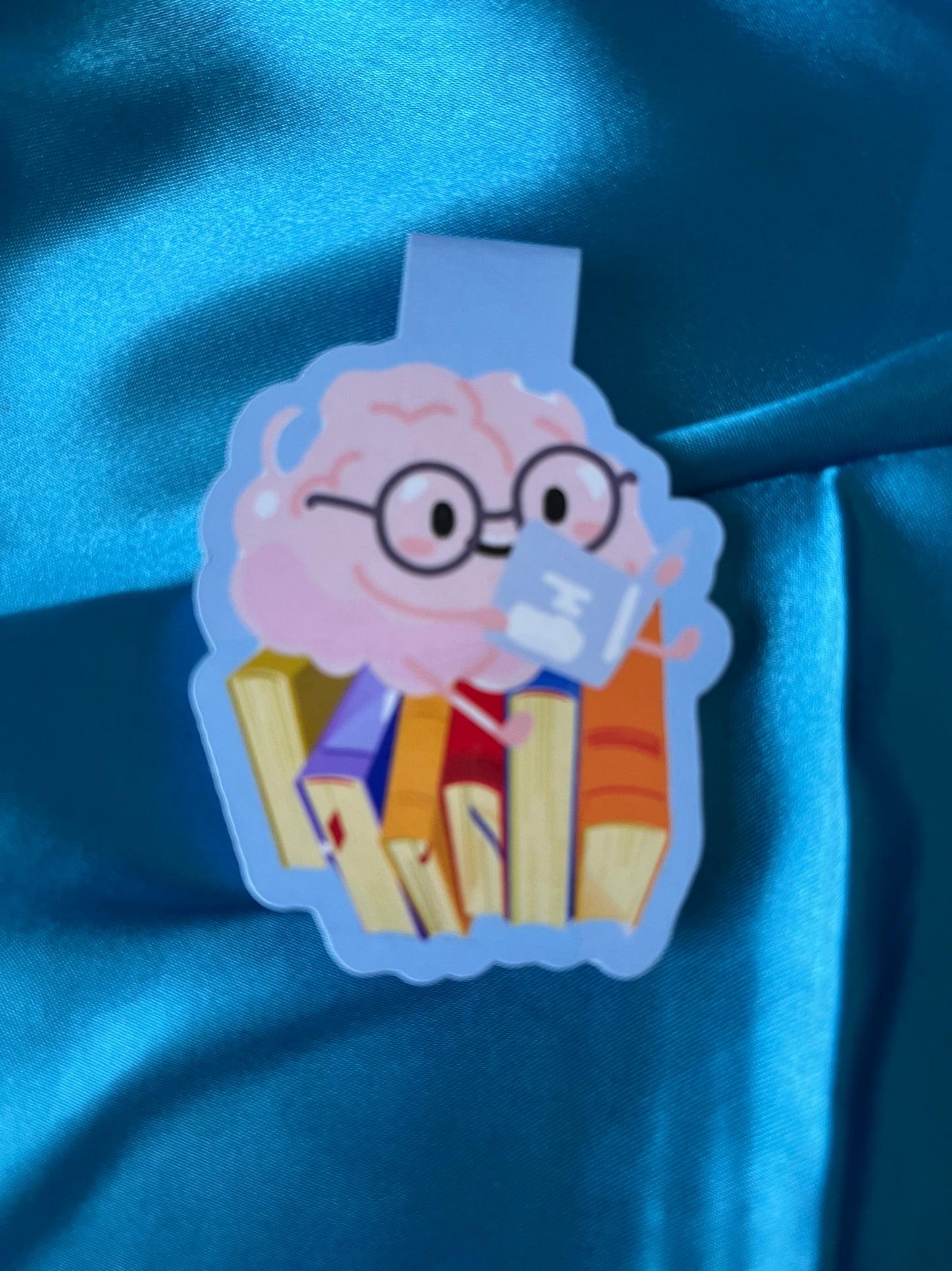 The blue version of the handmade magnetic fold-over brain bookmark