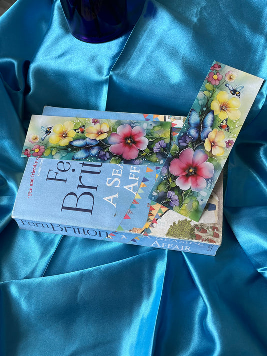 A handmade bookmark decorated with flowers and butterflies