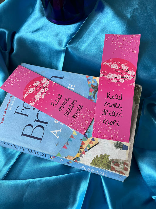A handmade bookmark illustrated with soft cherry blossom and an inspiring message